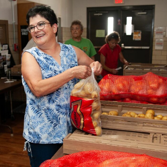 Volunteers unpack food received at Helping Hands of Roseville food pantry.