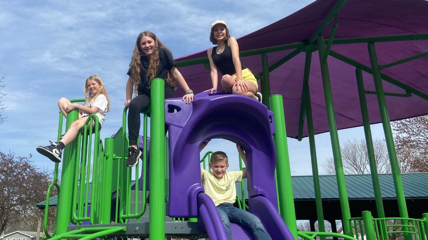Children play on the playground equipment build and dedicated to Maci Mulvey.